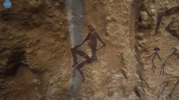 Reproducción de una pintura rupestre de una figura humana en rojo sobre fondo de roca de La Sarga Alcoy